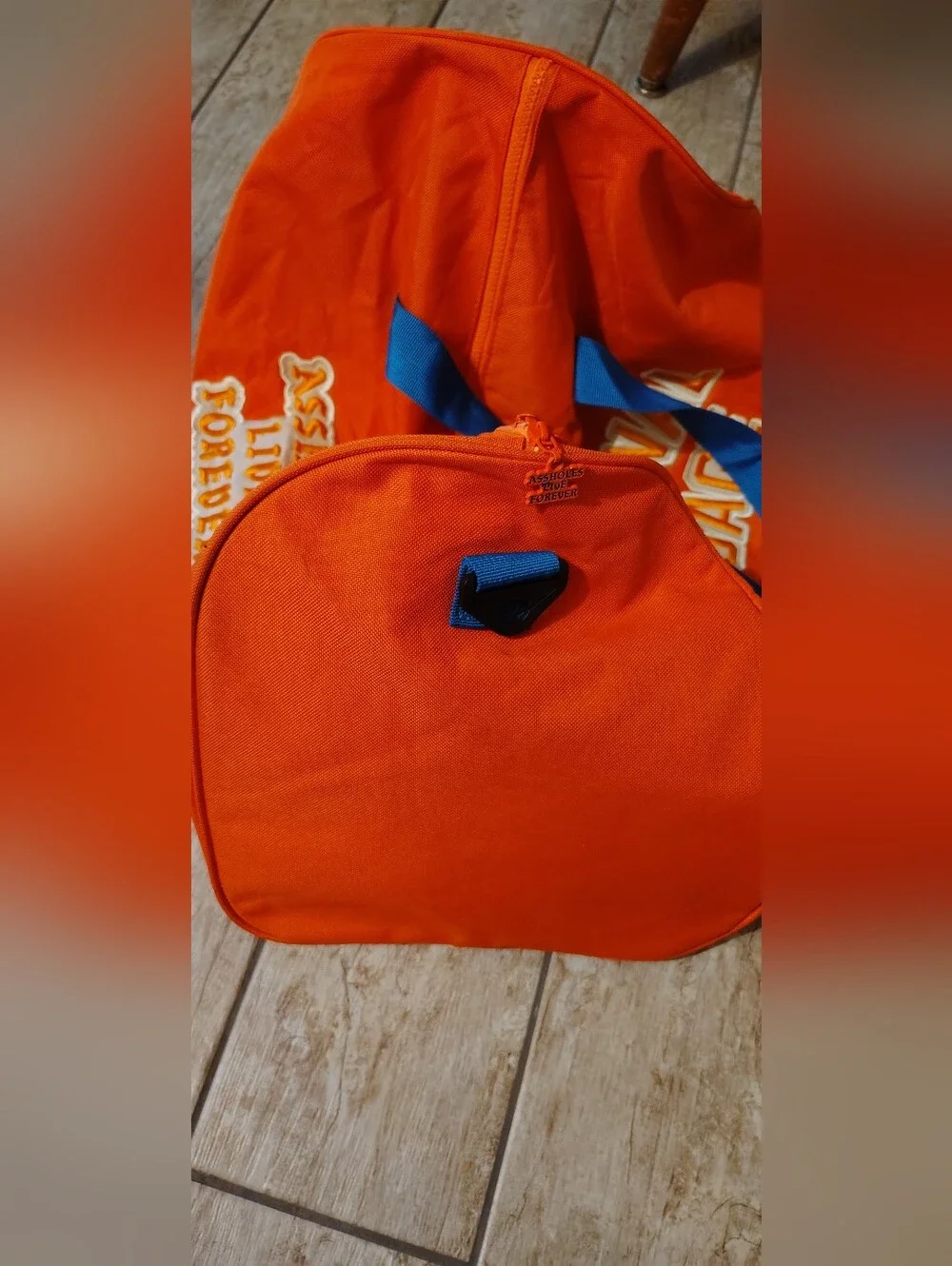 Emotional Baggage Orange Duffel Bag with Blue Handles